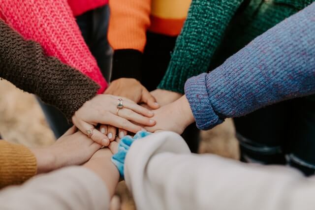 A bunch of hands all together in a circle.